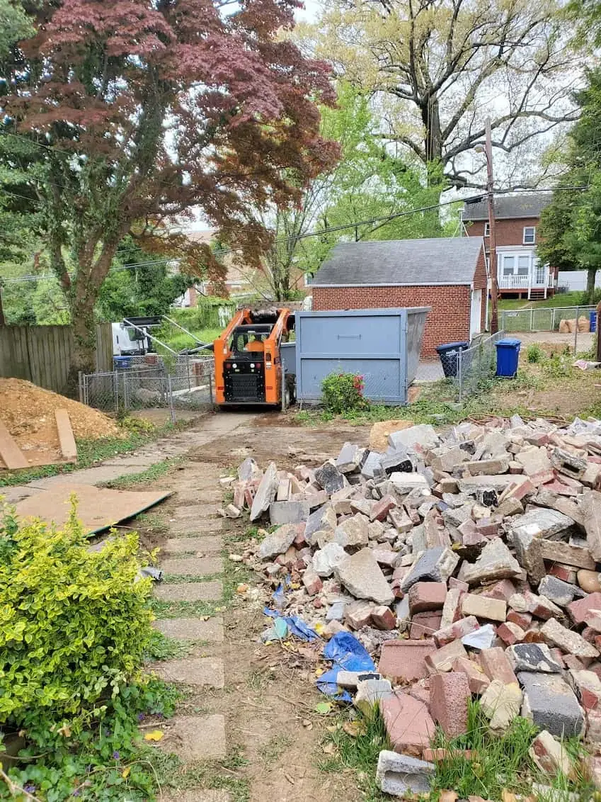 Roll off container set on a driveway at a renovation